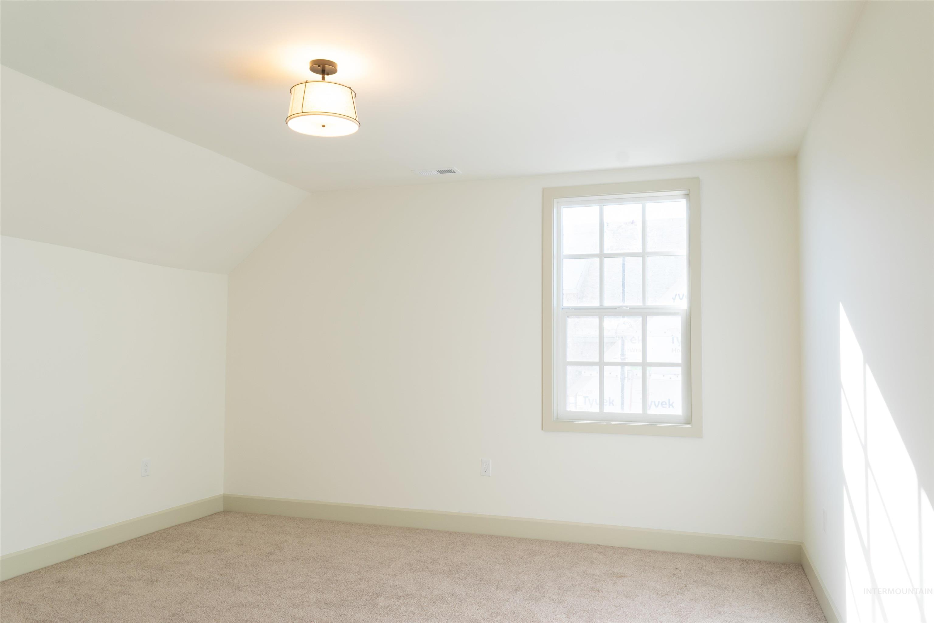 1560 Slonaker, Unit ONYX Moscow, ID 83843 - Photo 22 of 45 Additional living space with vaulted ceiling and light carpet