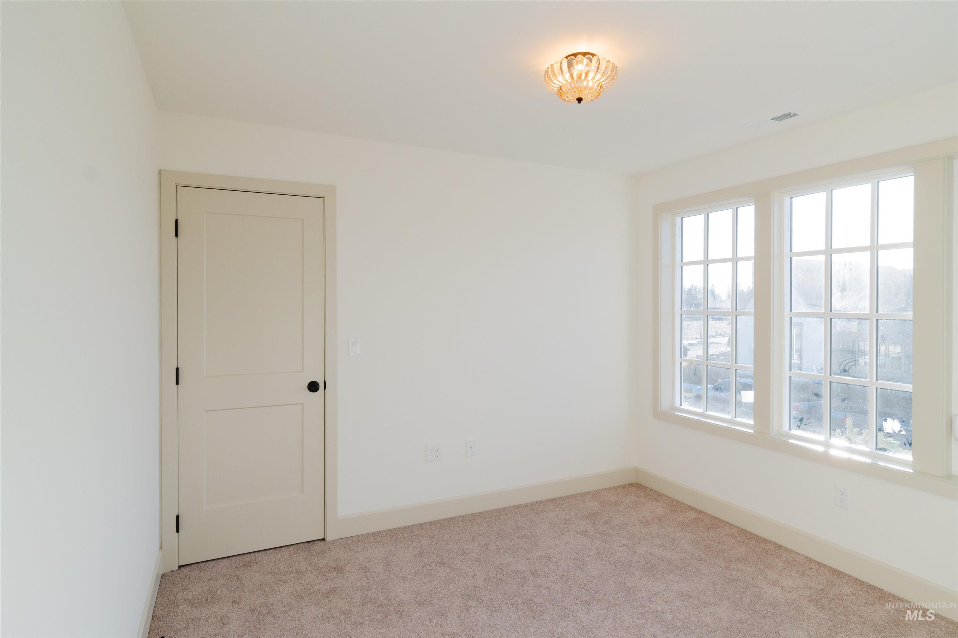 1560 Slonaker, Unit ONYX Moscow, ID 83843 - Photo 22 of 43 Empty room featuring carpet flooring and baseboards