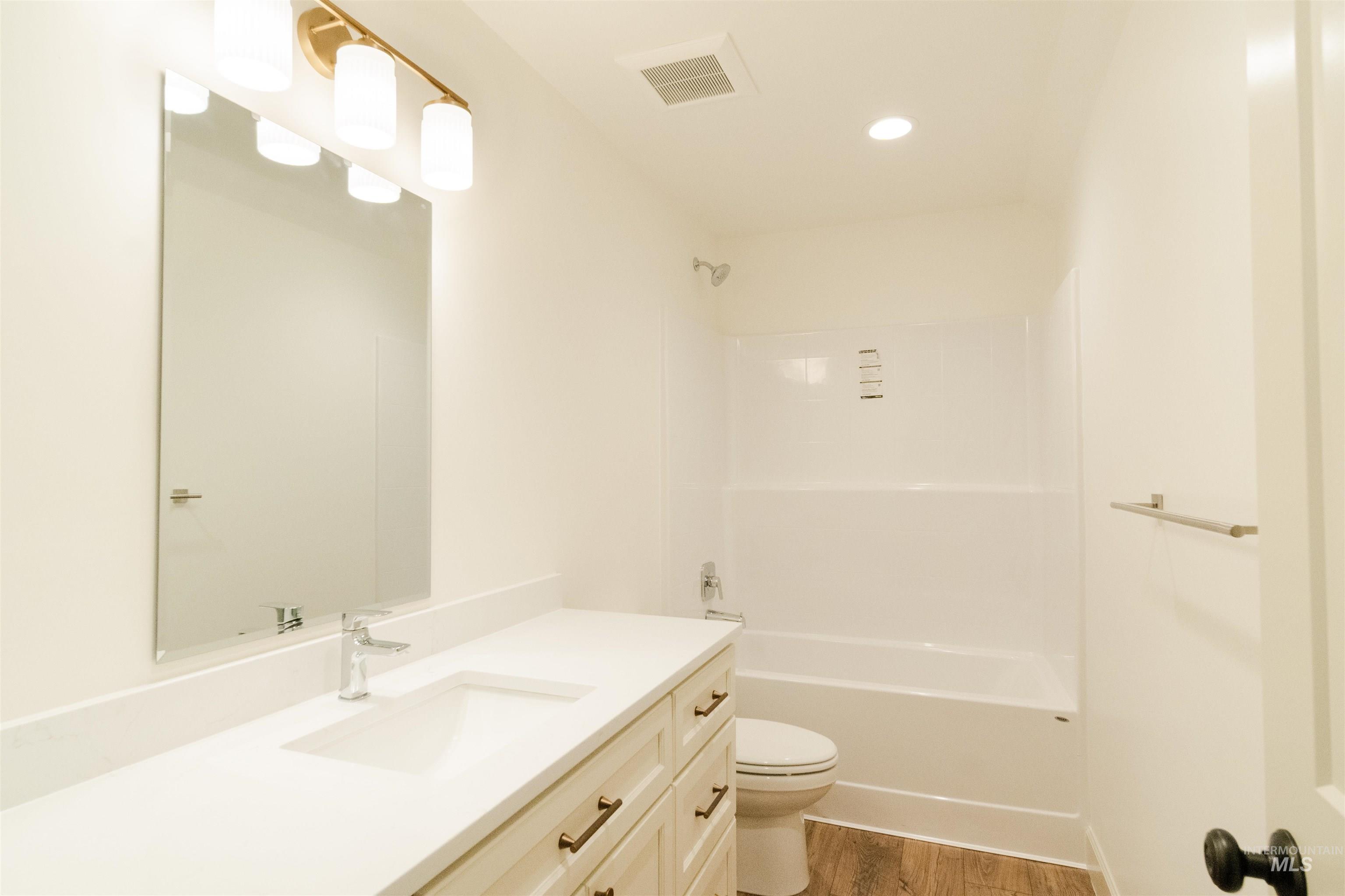 1560 Slonaker, Unit ONYX Moscow, ID 83843 - Photo 23 of 45 Bathroom featuring vanity, washtub / shower combination, dark wood-type flooring, and recessed lighting