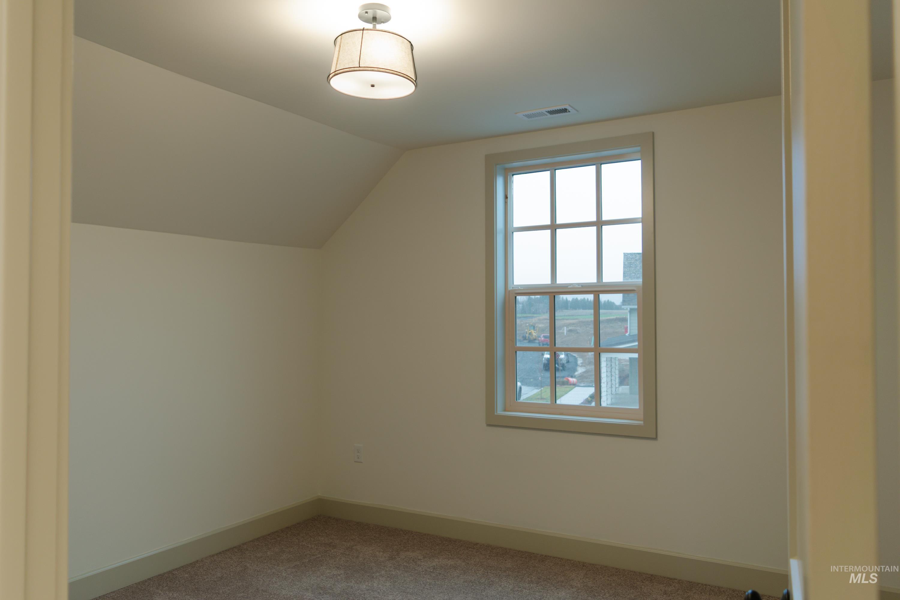 1560 Slonaker, Unit ONYX Moscow, ID 83843 - Photo 28 of 49 Additional living space featuring vaulted ceiling and carpet floors