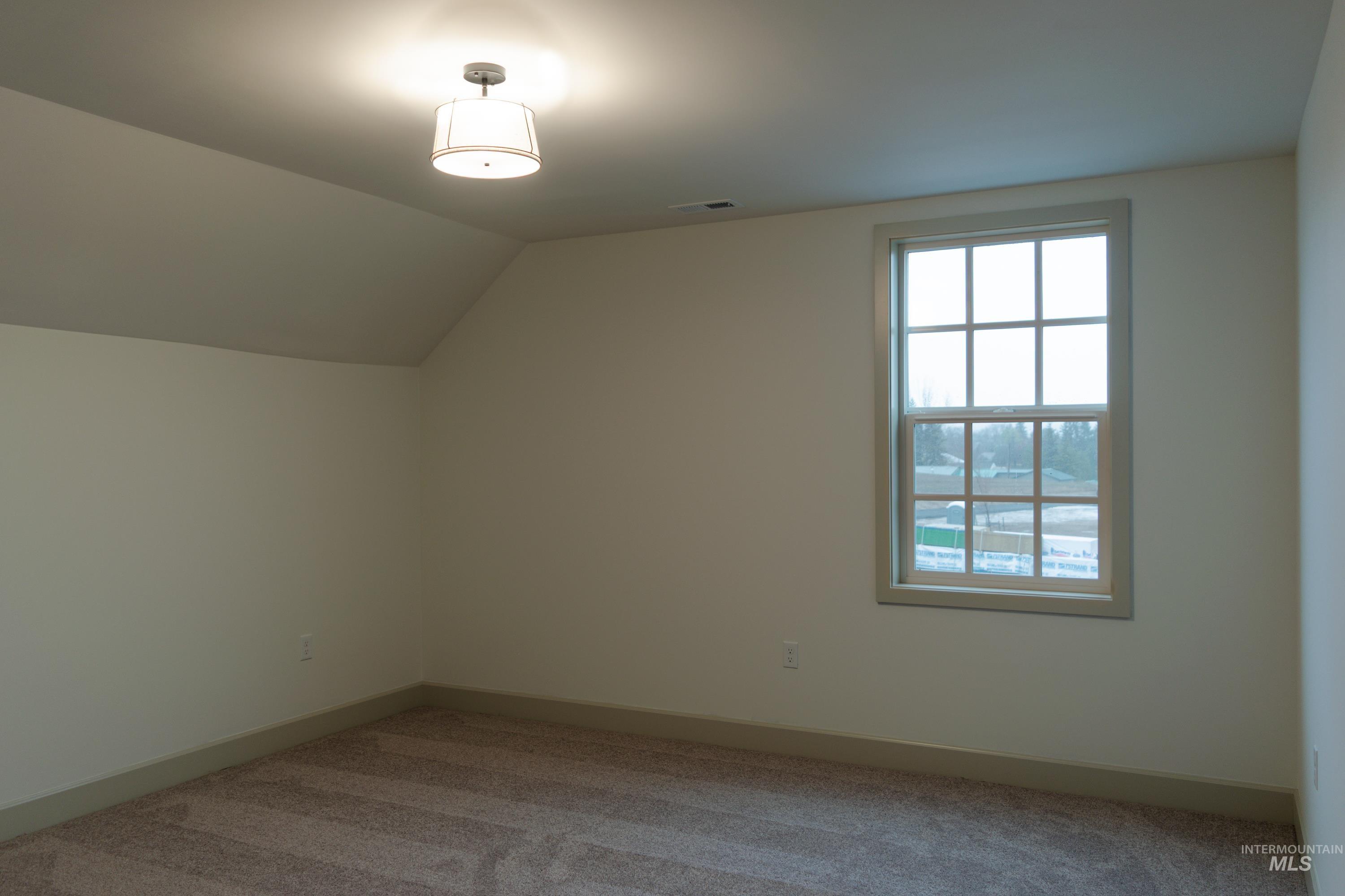 1560 Slonaker, Unit ONYX Moscow, ID 83843 - Photo 30 of 49 Additional living space featuring lofted ceiling and carpet flooring