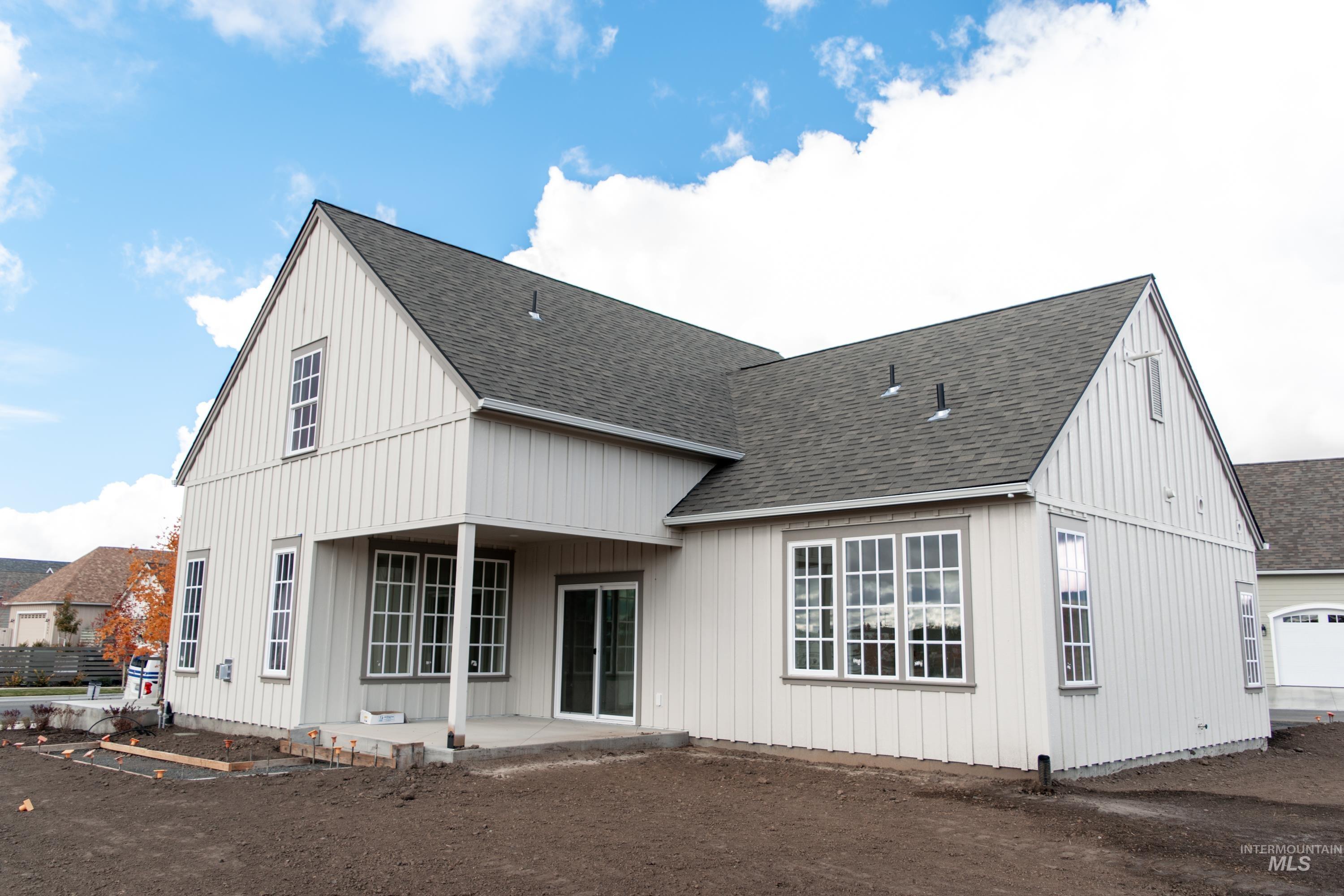 1560 Slonaker, Unit ONYX Moscow, ID 83843 - Photo 3 of 49 Back of house with a patio area, a shingled roof, and board and batten siding