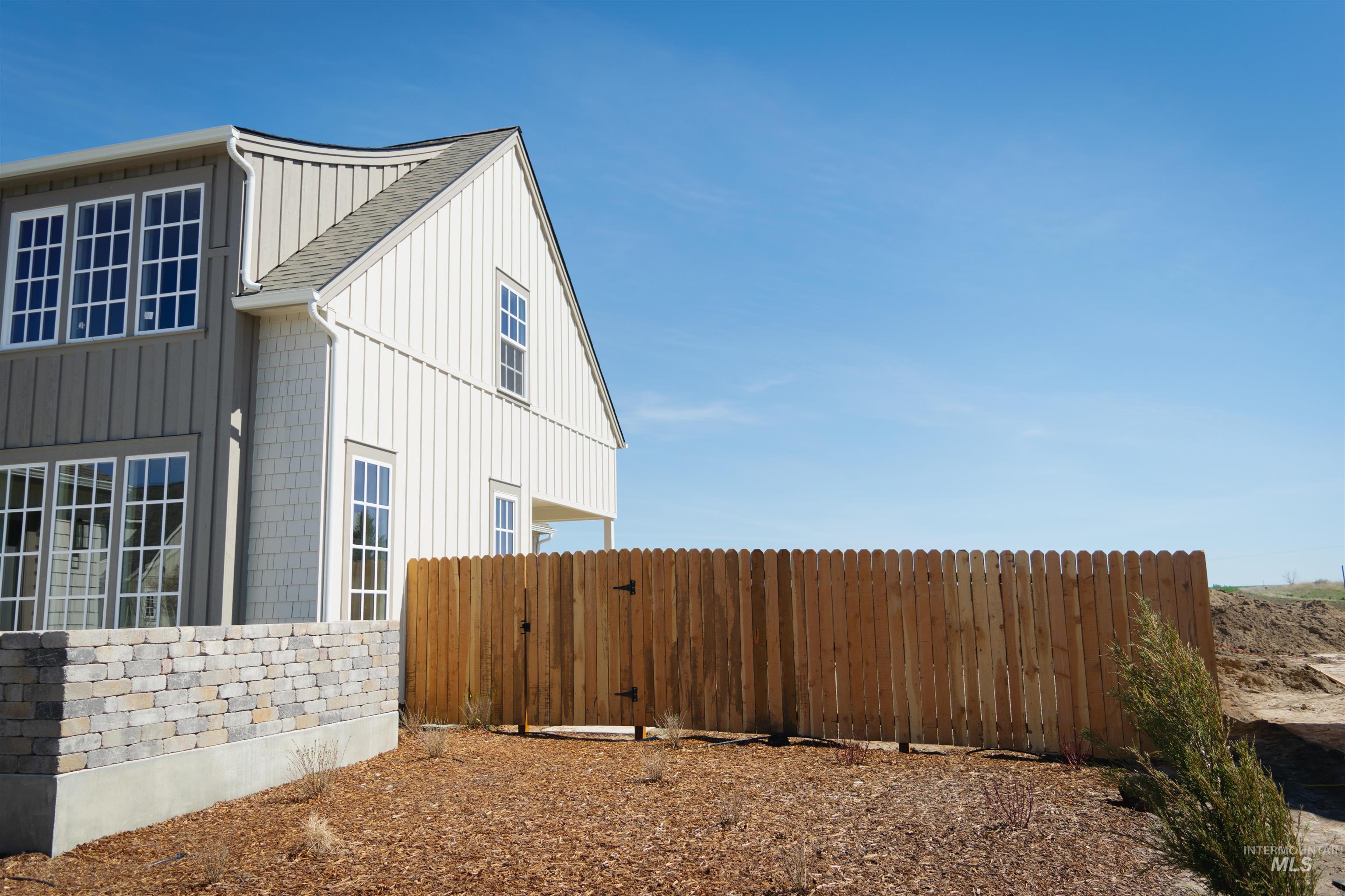 1560 Slonaker, Unit ONYX Moscow, ID 83843 - Photo 3 of 45 View of side of home featuring board and batten siding and a gate
