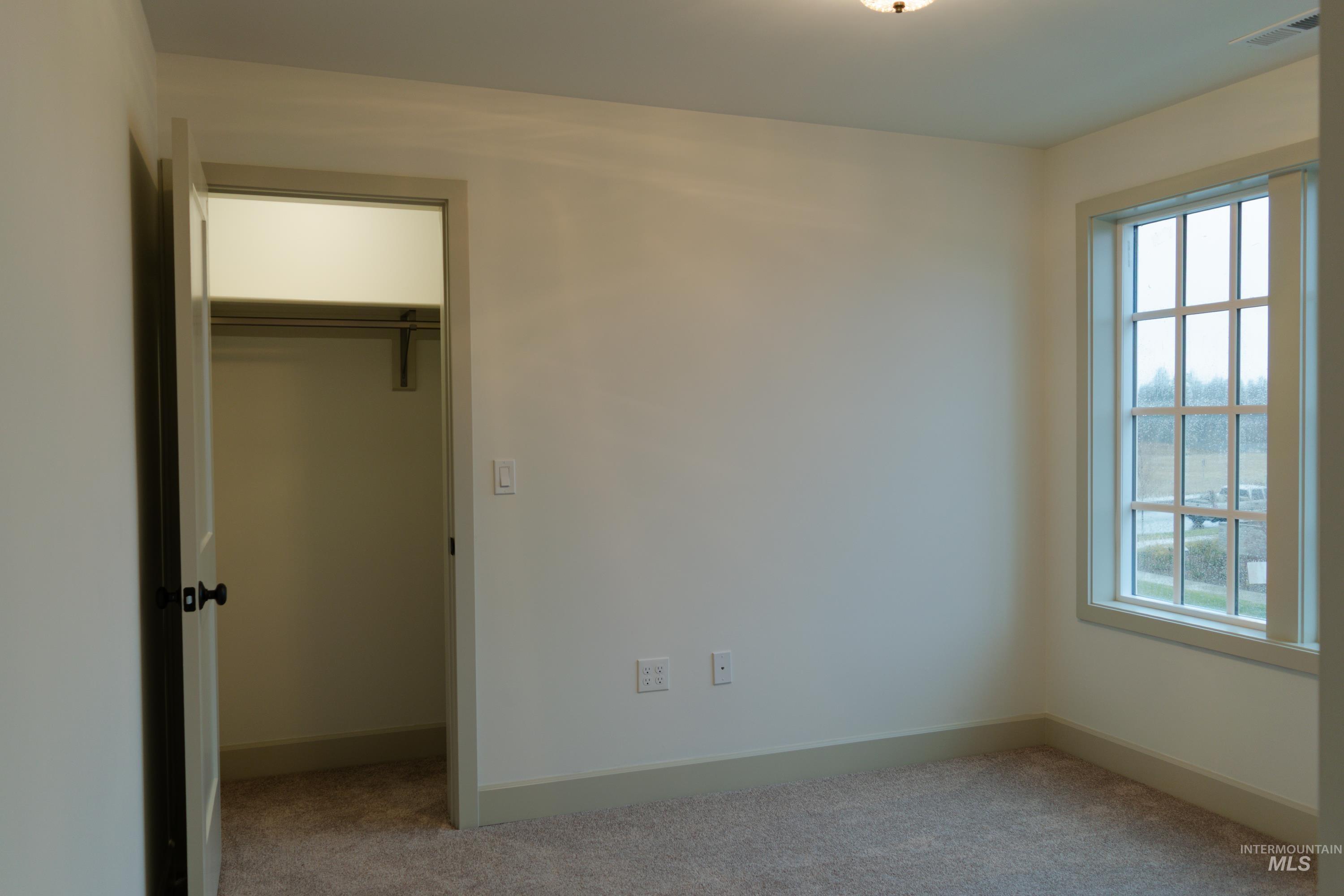 1560 Slonaker, Unit ONYX Moscow, ID 83843 - Photo 32 of 49 Unfurnished bedroom featuring carpet floors and a spacious closet