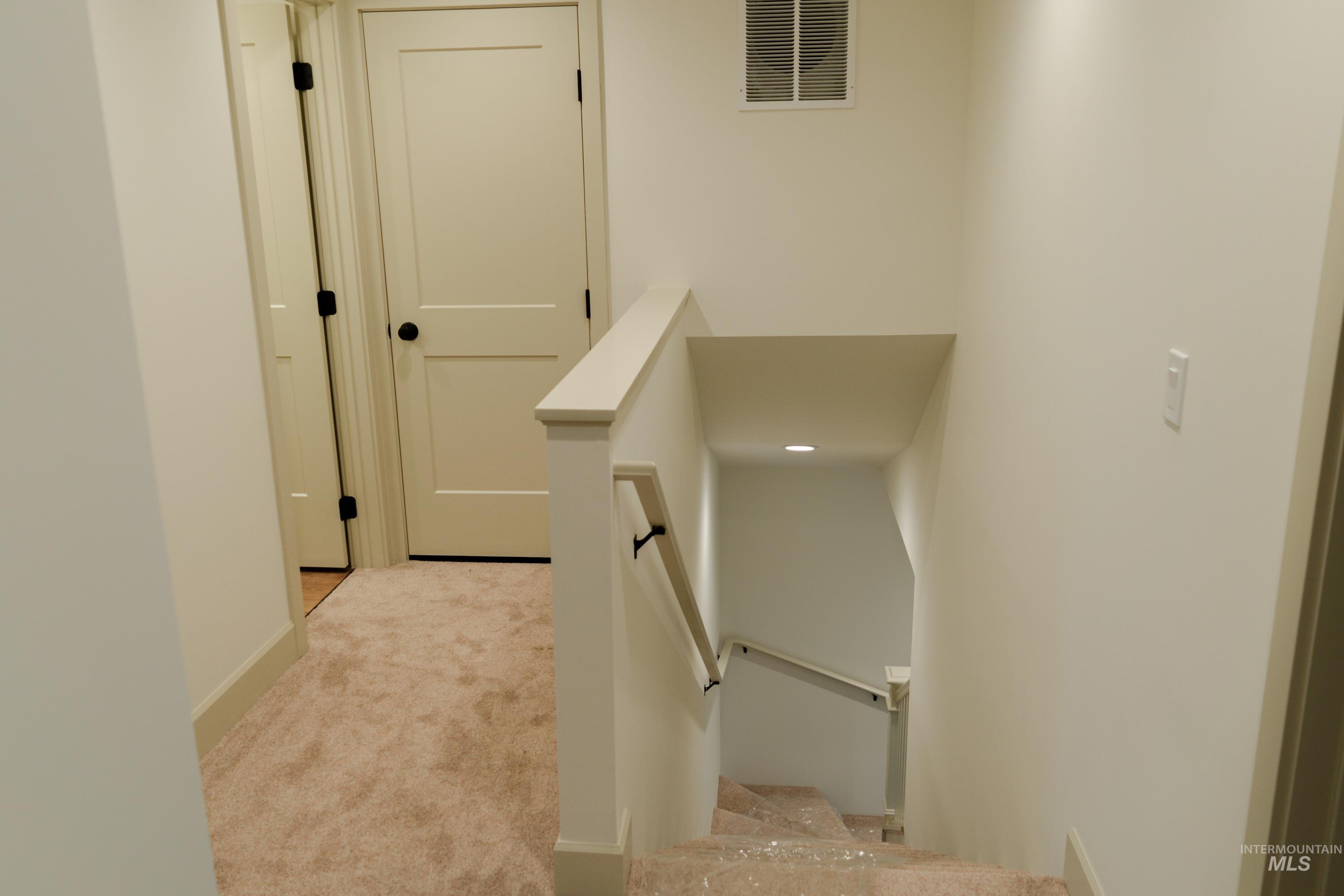 1560 Slonaker, Unit ONYX Moscow, ID 83843 - Photo 33 of 49 Stairway with carpet flooring and baseboards