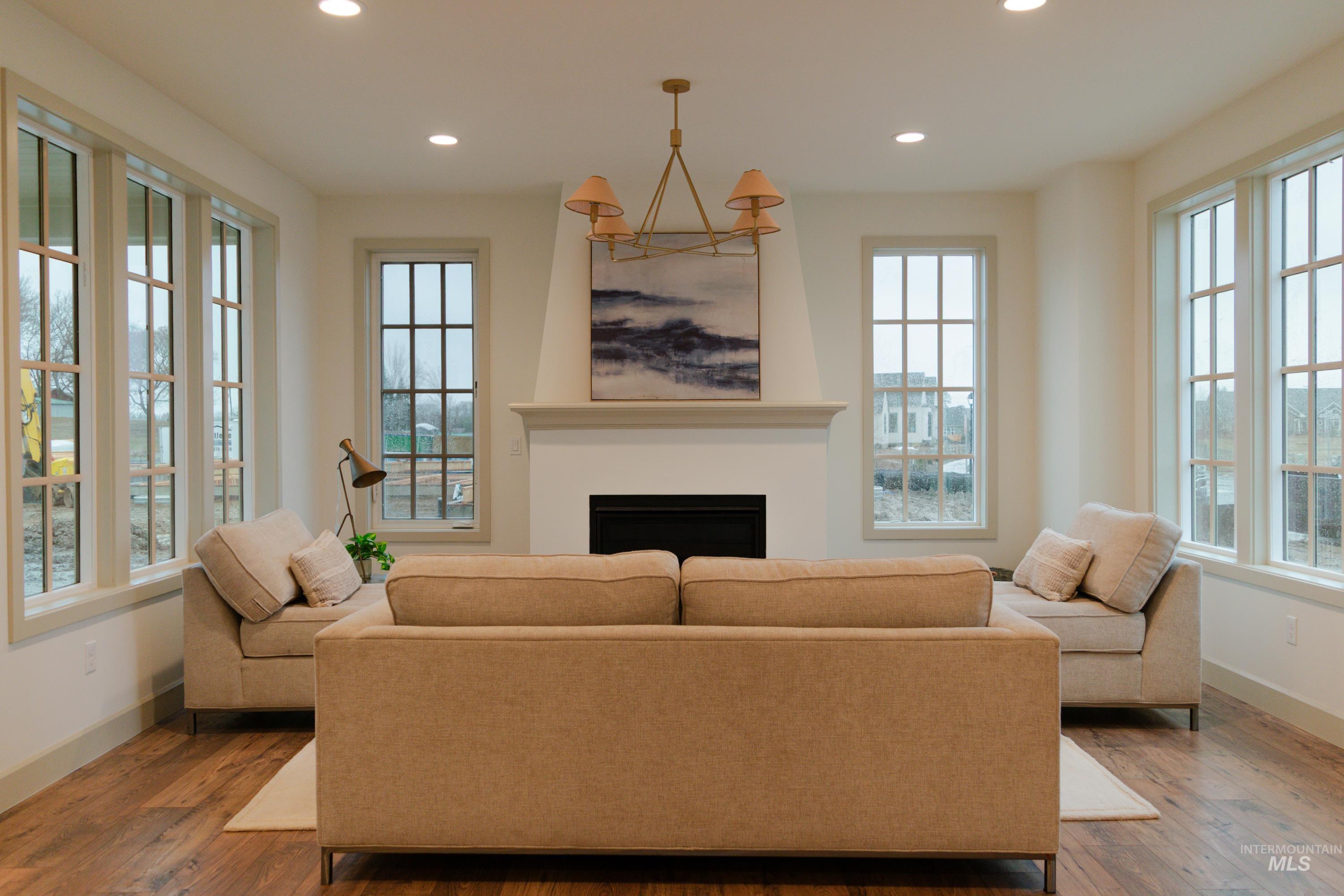 1560 Slonaker, Unit ONYX Moscow, ID 83843 - Photo 5 of 49 Living room with a fireplace, recessed lighting, plenty of natural light, and hardwood / wood-style floors