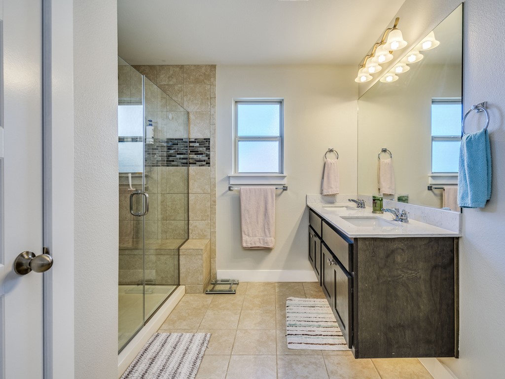9500 Hunter Lane Austin, TX 78748 - Photo 14 of 25 a bathroom with a sink a mirror and shower