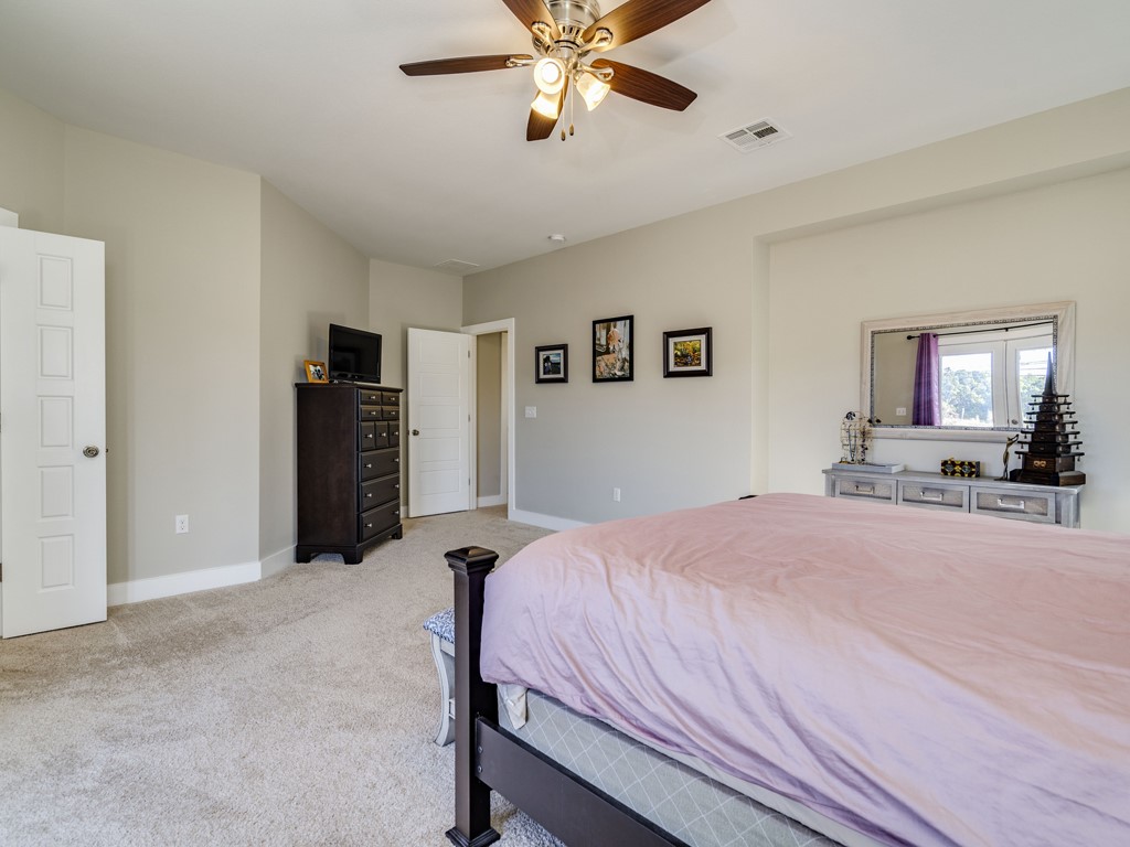 9500 Hunter Lane Austin, TX 78748 - Photo 15 of 25 a bedroom with a bed and a chandelier