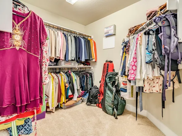 a view of walk in closet with clothes