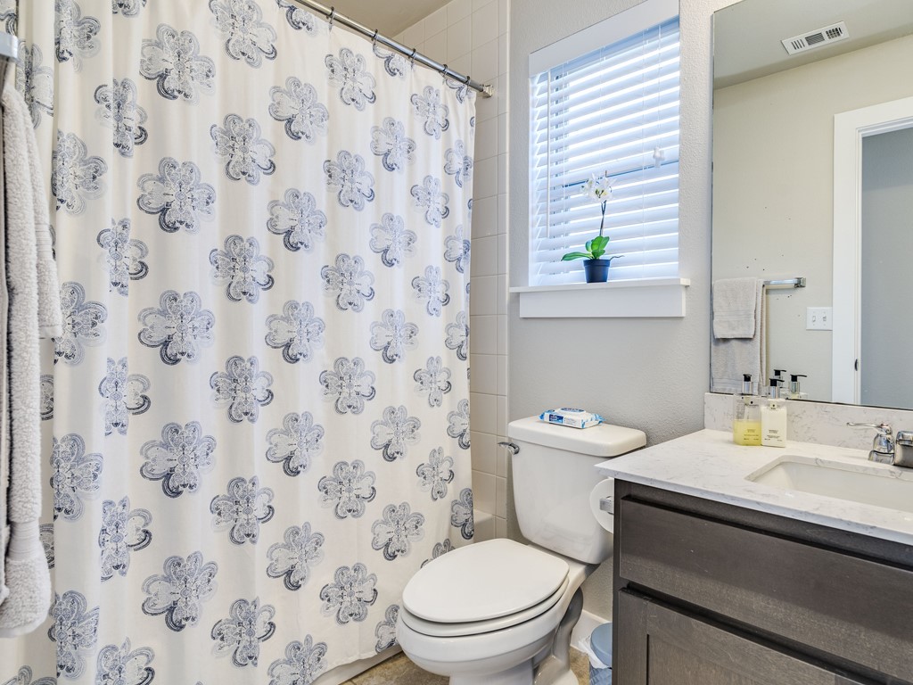 9500 Hunter Lane Austin, TX 78748 - Photo 21 of 25 a bathroom with a granite countertop sink a toilet and a mirror