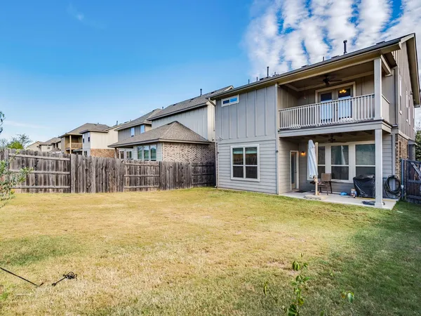 a yellow house with swimming pool in front of it