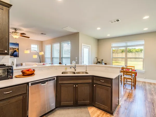 a kitchen with a sink a window and dining table