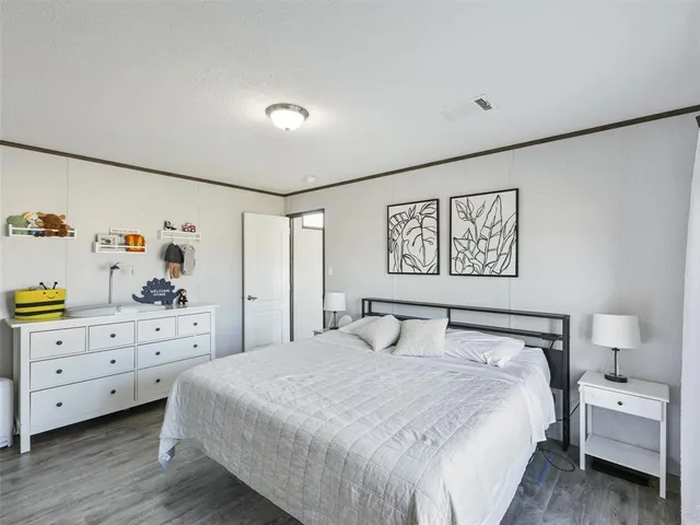 a bedroom with a bed and a night stand