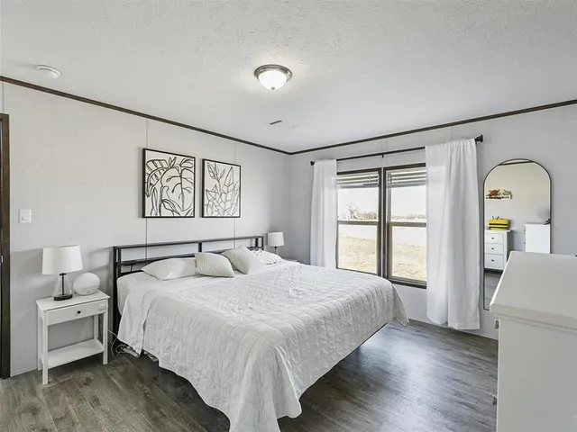 a bedroom with a large bed and a window