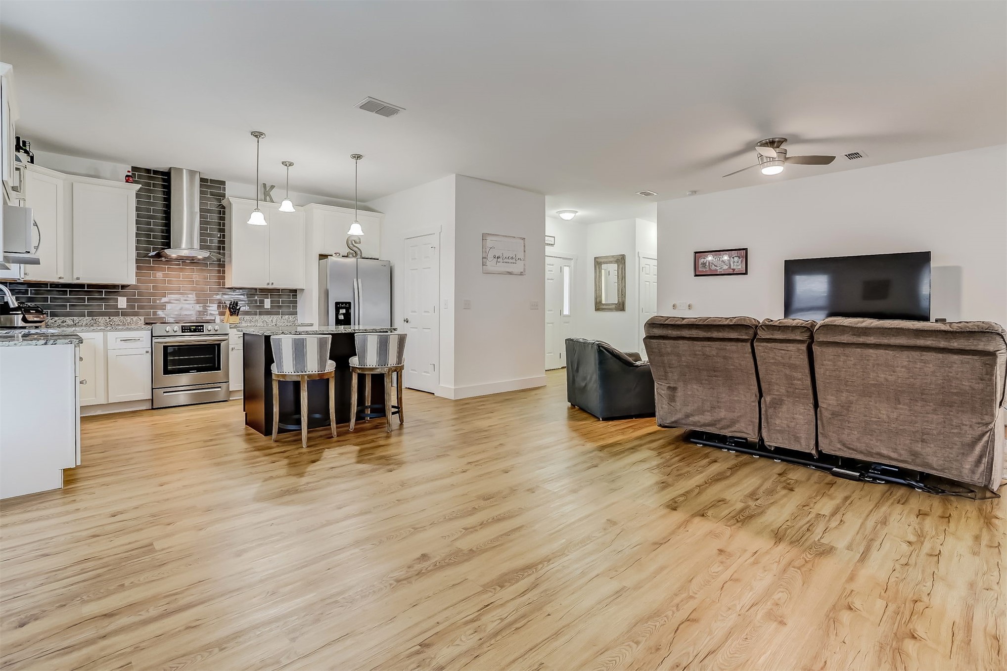 1421 Hickory Street Fernandina Beach, FL 32034 - Photo 3 of 22 a living room with furniture a flat screen tv and kitchen view