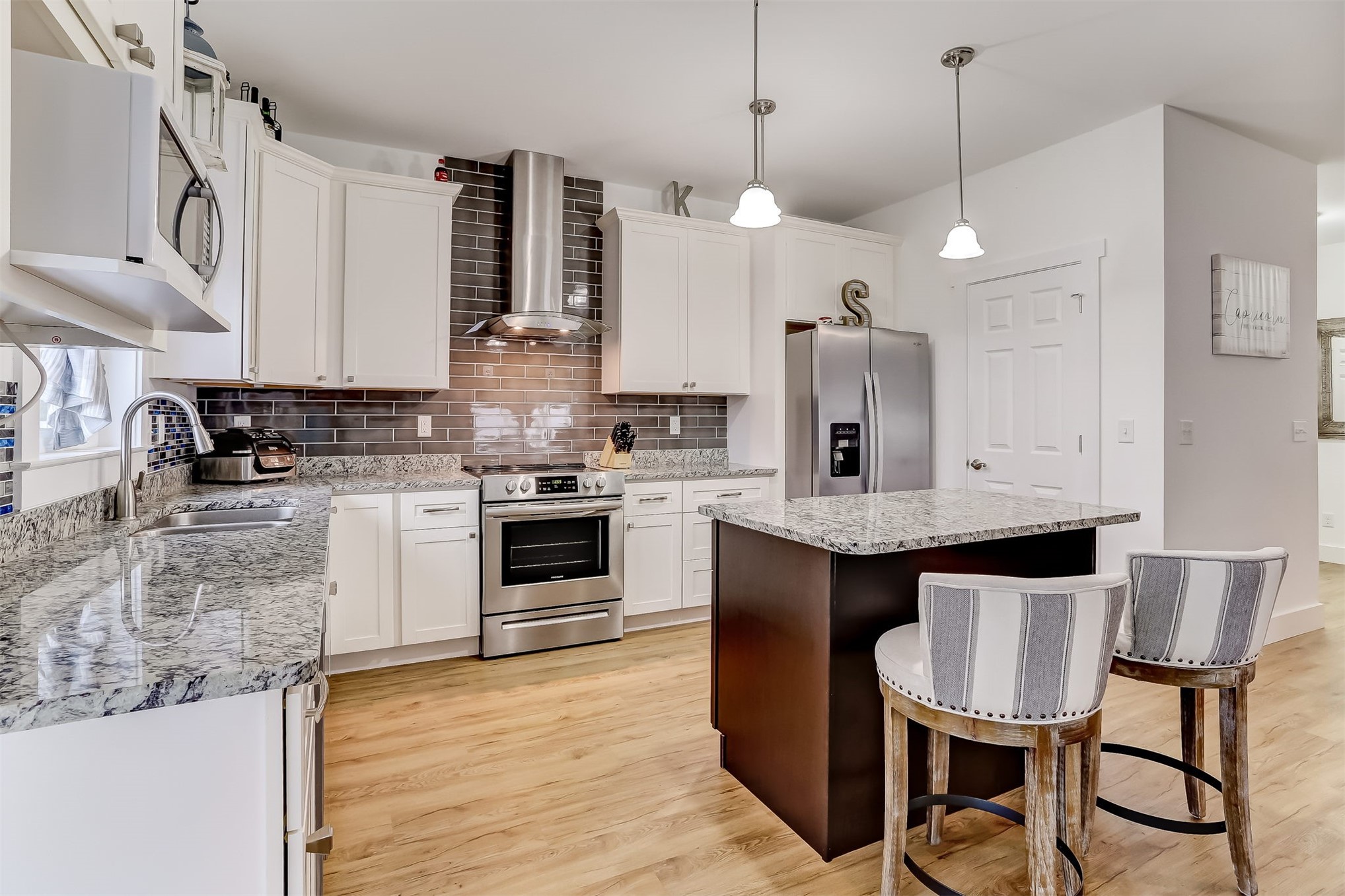 1421 Hickory Street Fernandina Beach, FL 32034 - Photo 5 of 22 a kitchen with stainless steel appliances granite countertop a sink a stove a refrigerator cabinets and chairs