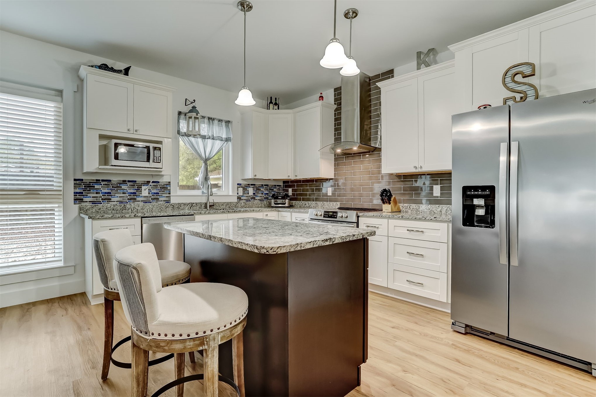 1421 Hickory Street Fernandina Beach, FL 32034 - Photo 6 of 22 a kitchen with stainless steel appliances granite countertop a sink a stove a table and chairs