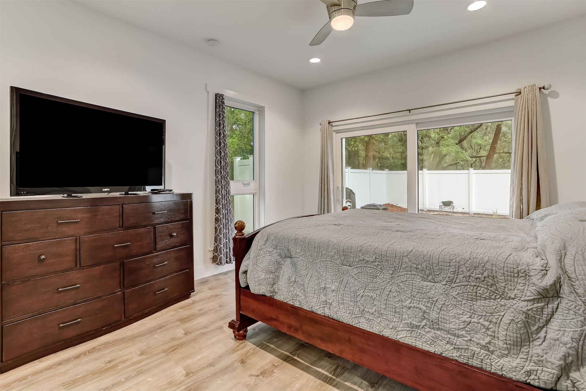 1421 Hickory Street Fernandina Beach, FL 32034 - Photo 10 of 22 a bedroom with a bed and a flat screen tv