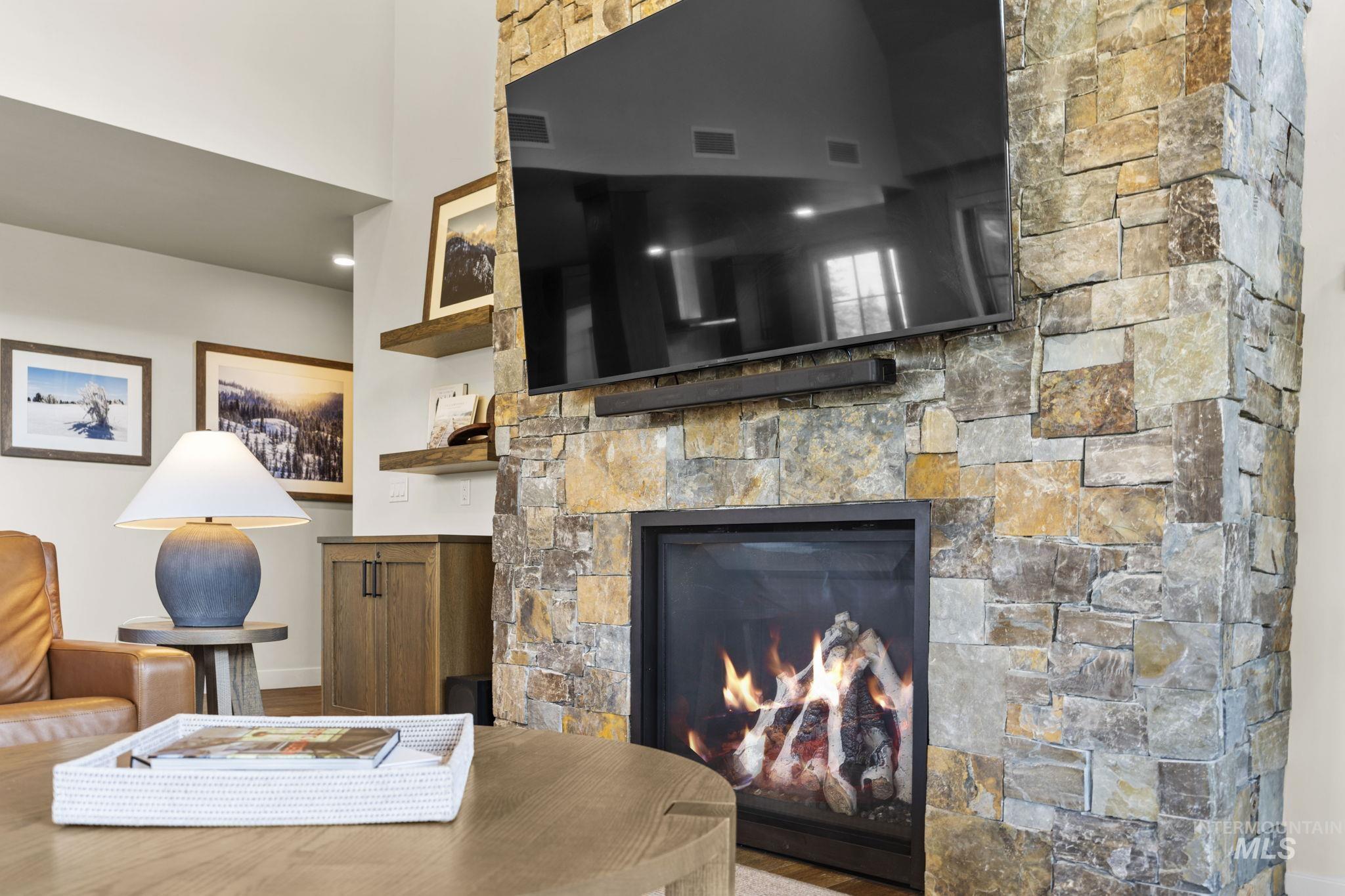 700 Village Drive, Unit 403 Donnelly, ID 83615 - Photo 13 of 43 Living area featuring a stone fireplace and baseboards