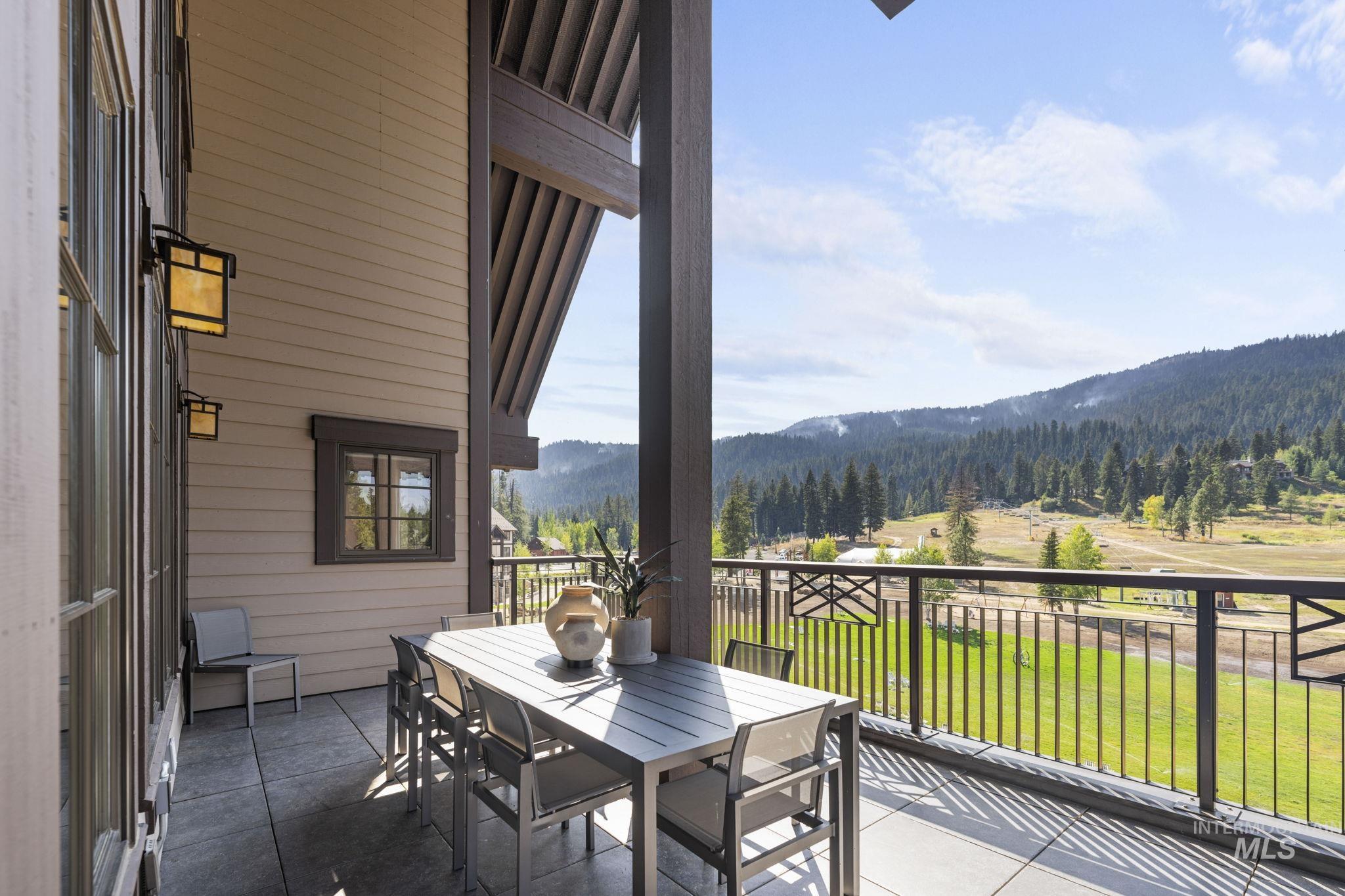 700 Village Drive, Unit 403 Donnelly, ID 83615 - Photo 2 of 43 Balcony with a mountain view, outdoor dining area, and a forest view