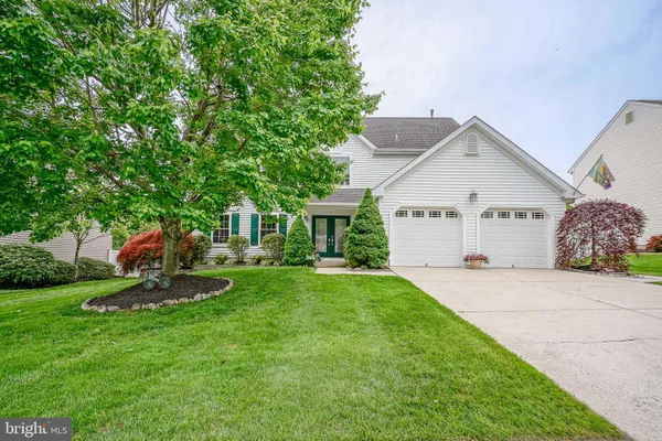 a front view of a house with a yard and porch