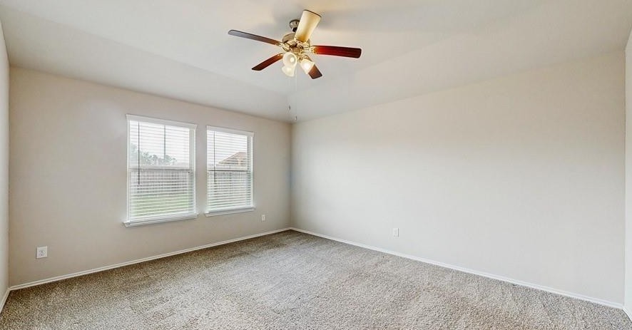 18277 Eaton Mill Drive New Caney, TX 77357 - Photo 14 of 28 an empty room with ceiling fan and window