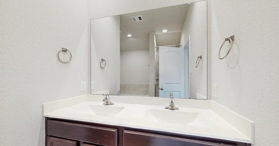 18277 Eaton Mill Drive New Caney, TX 77357 - Photo 16 of 28 a bathroom with a sink and a mirror