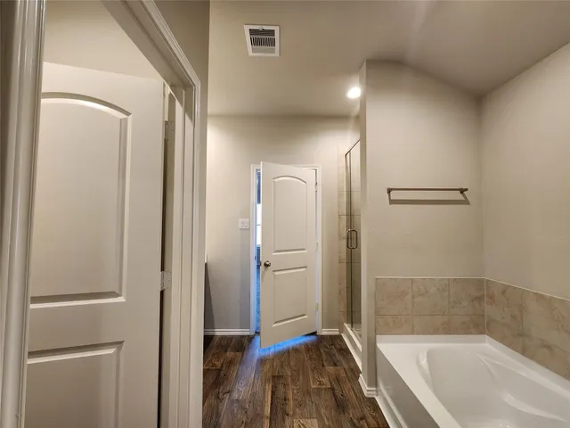a bathroom with a tub and shower