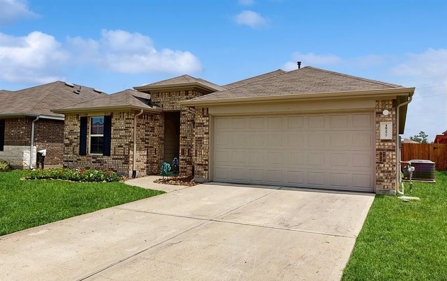 18277 Eaton Mill Drive New Caney, TX 77357 - Photo 2 of 28 a front view of a house with garden