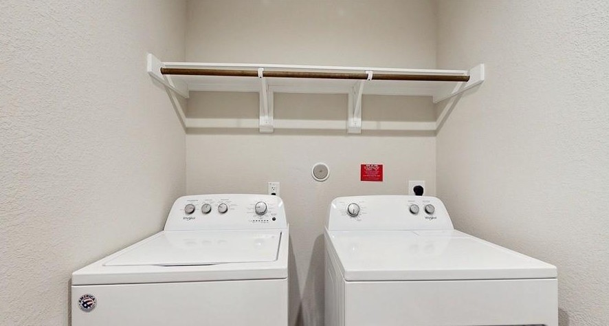 18277 Eaton Mill Drive New Caney, TX 77357 - Photo 24 of 28 a utility room with dryer and washer