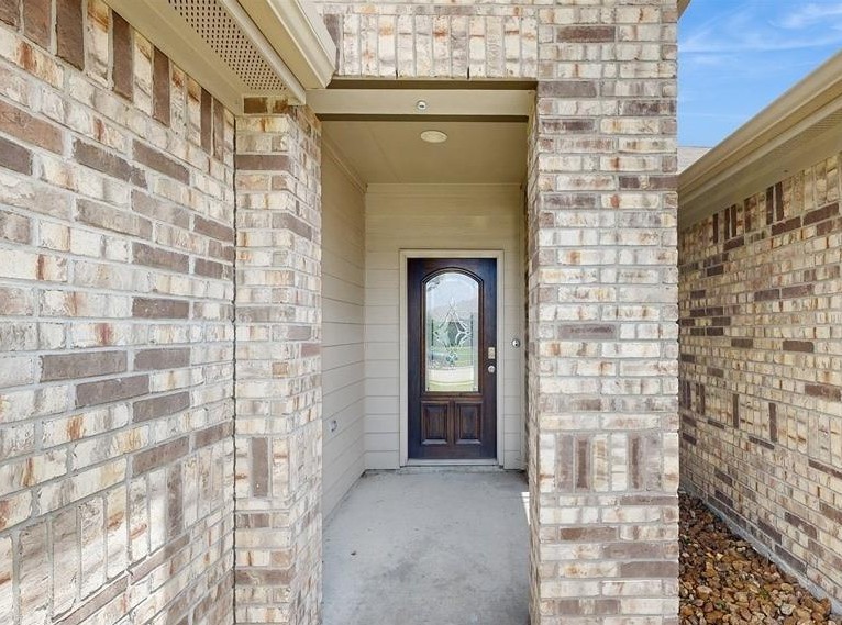 18277 Eaton Mill Drive New Caney, TX 77357 - Photo 4 of 28 a front view of a house with a garden