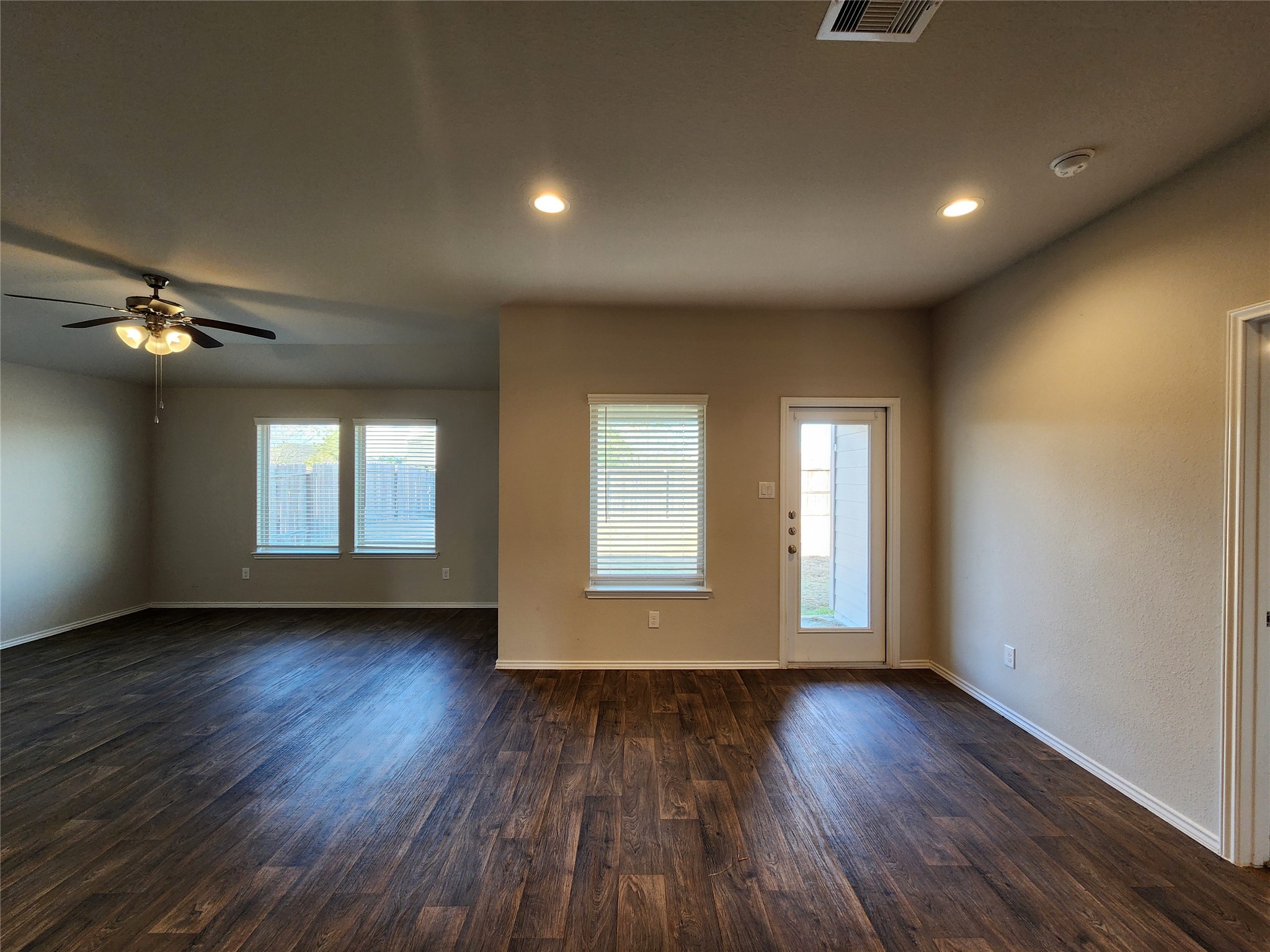 18277 Eaton Mill Drive New Caney, TX 77357 - Photo 6 of 28 a view of an empty room with wooden floor and a window