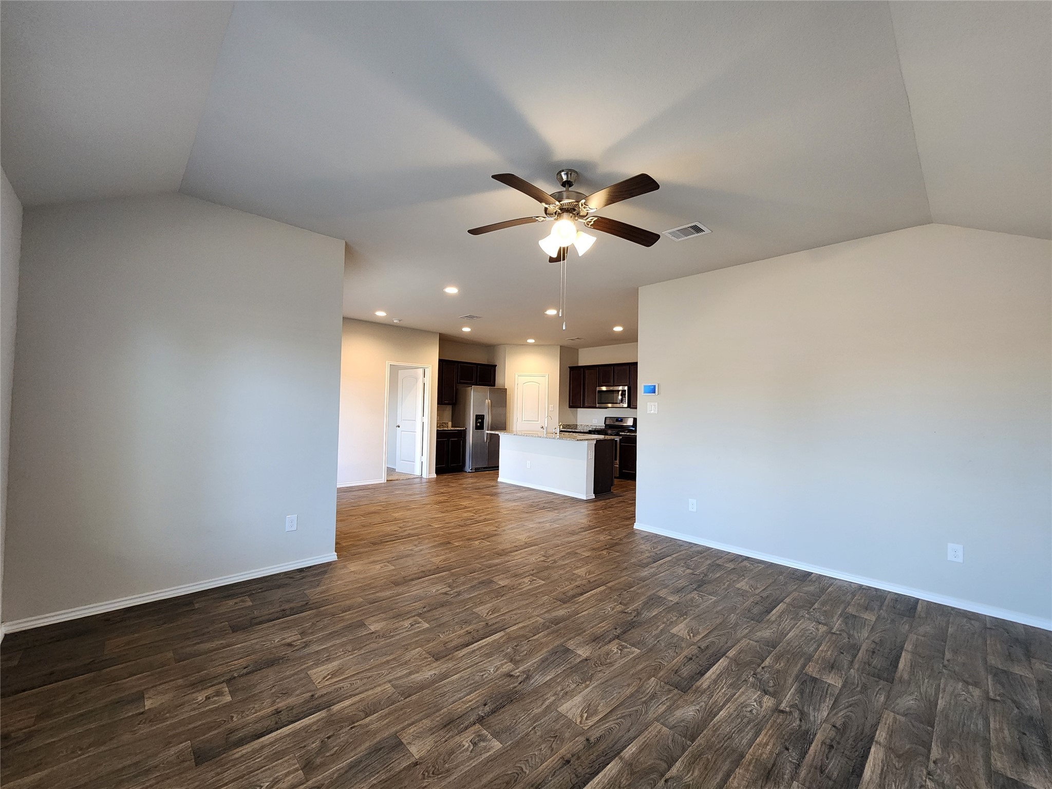 18277 Eaton Mill Drive New Caney, TX 77357 - Photo 7 of 28 a view of an empty room with a kitchen and a window