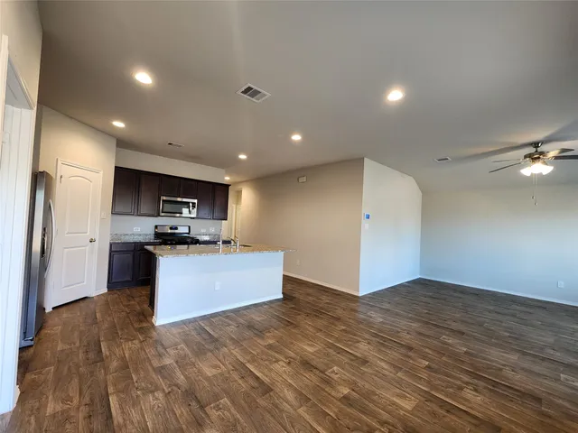 a view of kitchen with refrigerator and stove