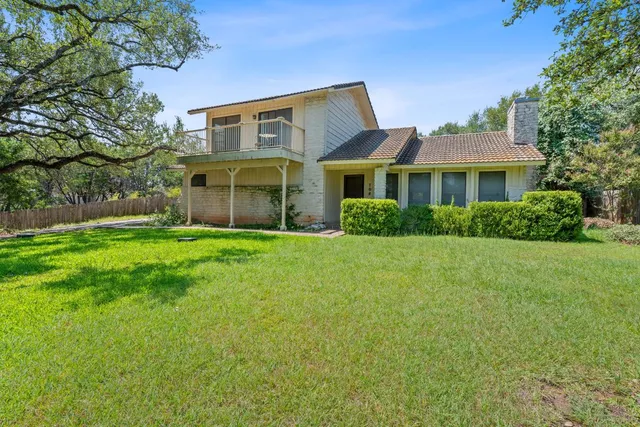 a front view of house with yard and green space