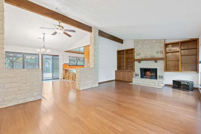 a view of a livingroom with furniture wooden floor a fireplace