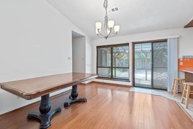 a room with wooden floor and large windows