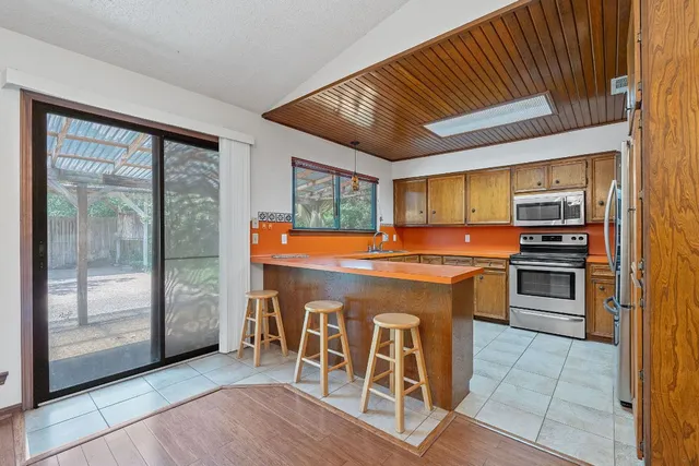 a kitchen with stainless steel appliances granite countertop a stove and a refrigerator