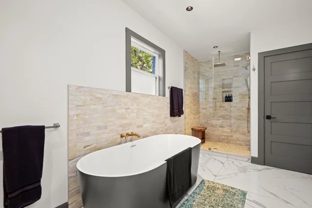 a bathroom with a bathtub and a sink