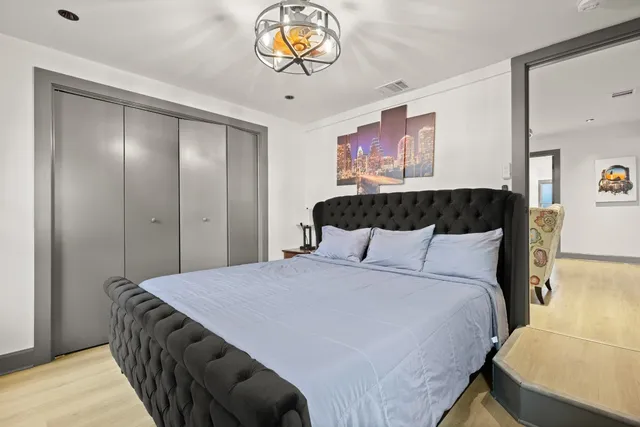 a bedroom with a bed and a chandelier