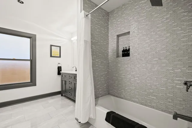 a bathroom with a tub and a shower