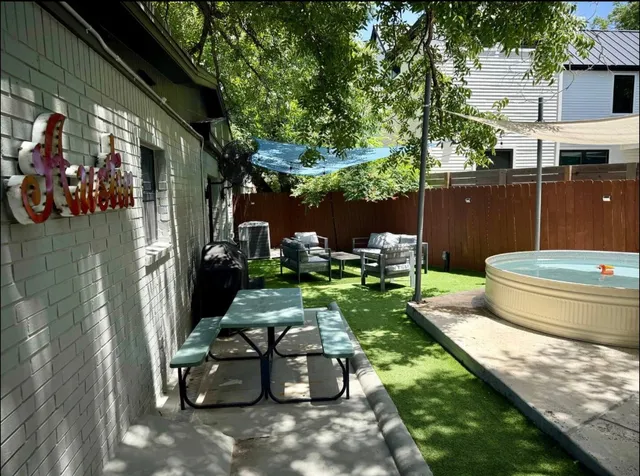 a view of a backyard with sitting area