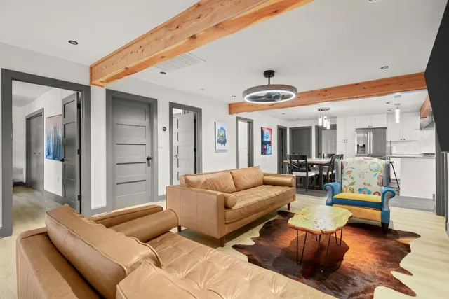 a living room with furniture and view of kitchen
