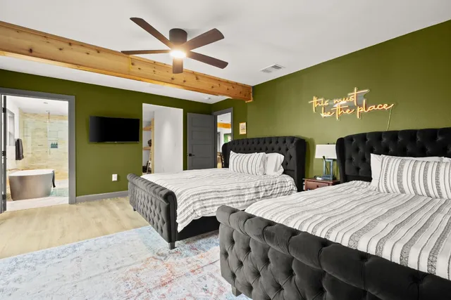 a bedroom with a bed and a chandelier