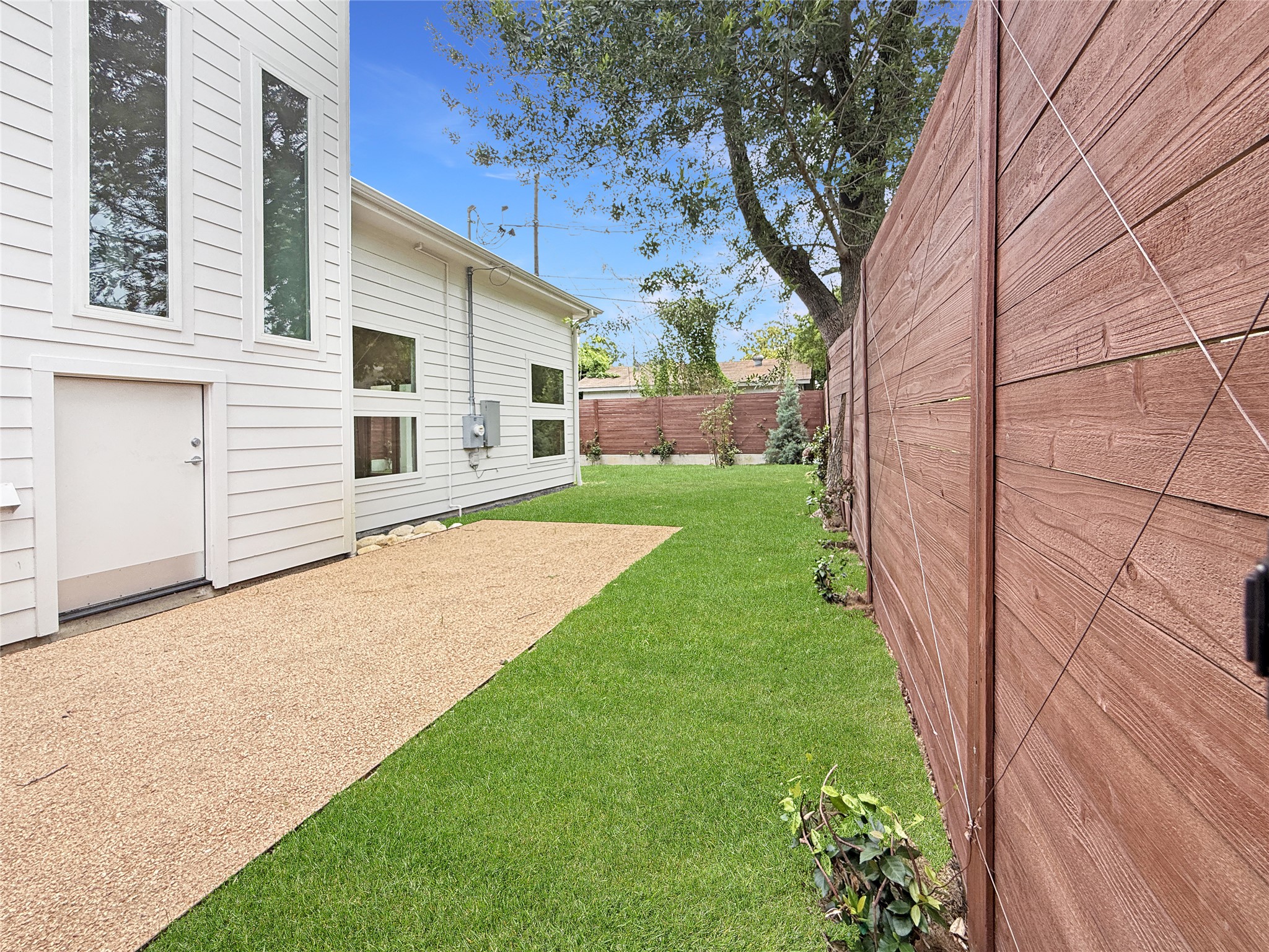 127 Frederick Street Austin, TX 78704 - Photo 32 of 34 Side lawn with 20' parking pad + door to storage