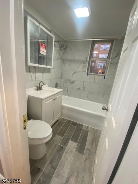 555 Westminster Avenue, Unit 4 Elizabeth, NJ 07208 - Photo 5 of 5 a bathroom with a toilet a sink and bathtub