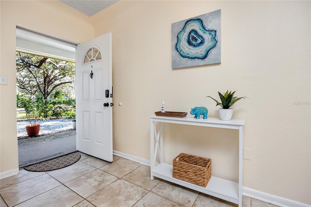 5596 100th Way North St. Petersburg, FL 33708 - Photo 37 of 67 a hallway with painting and a potted plant