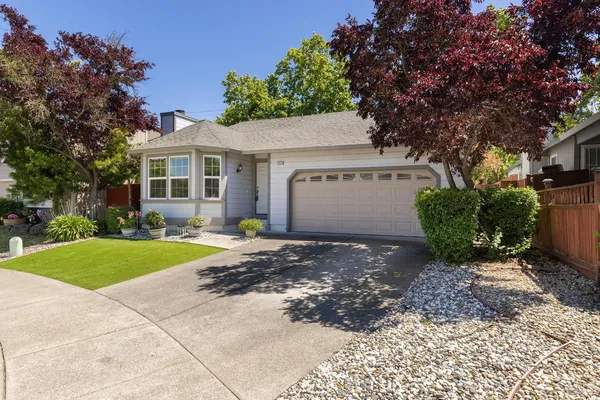 a view of a house with a yard and garage