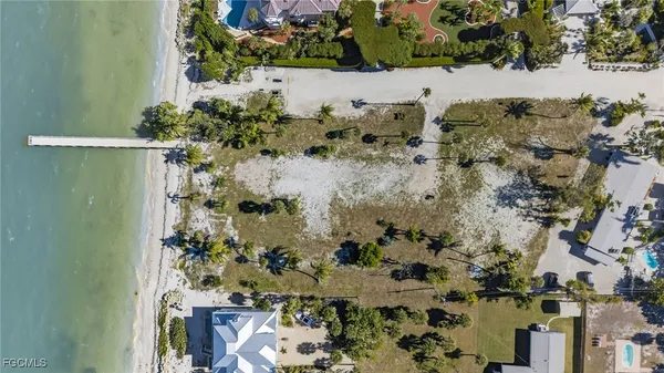 an aerial view of a houses with a yard