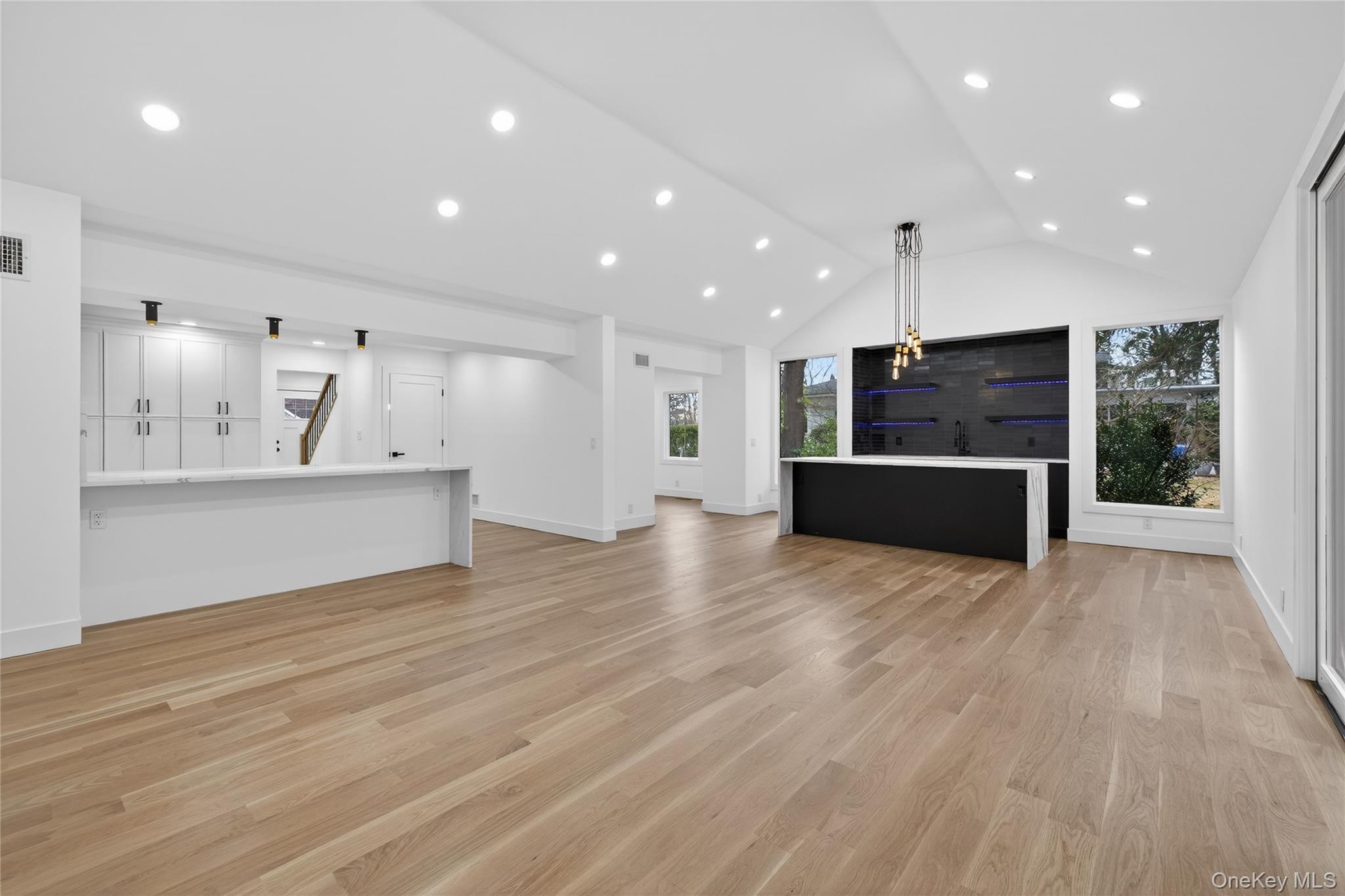 199 Salem Road East Hills, NY 11577 - Photo 3 of 40 Unfurnished living room with recessed lighting, lofted ceiling, and light wood-style floors